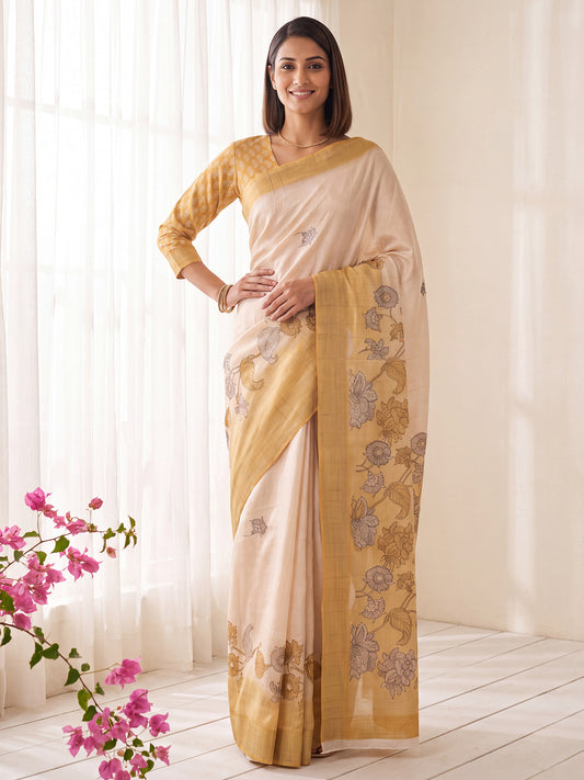 Woman wearing white satin silk saree with traditional indian motif work and mustard blouse