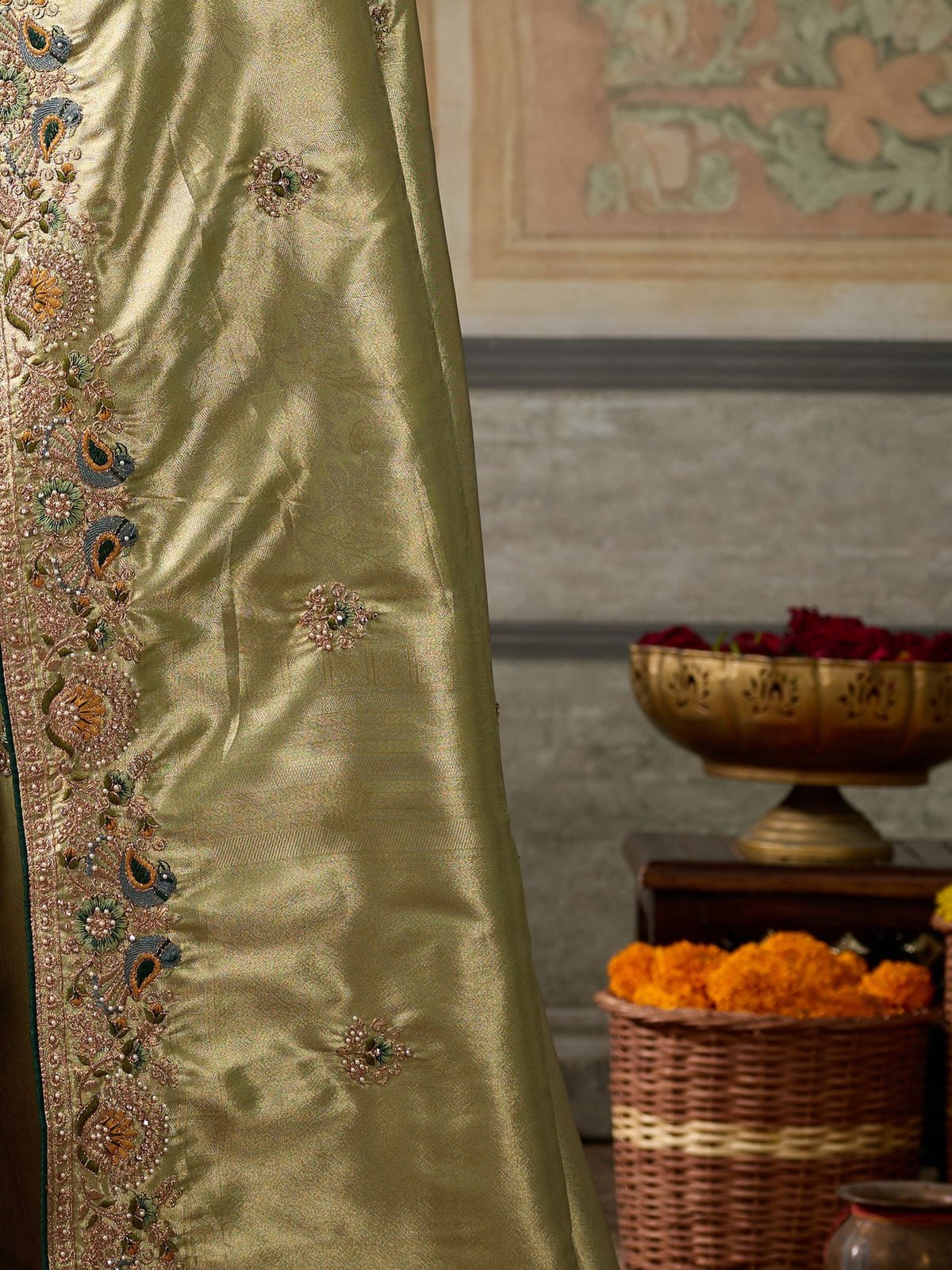 Pallu detail of olive silk blend saree showing ornamented surface design and embellished border