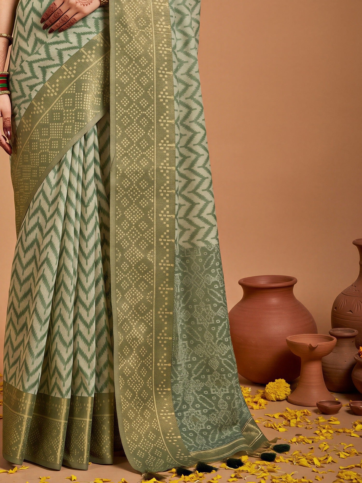 Pallu detail of green viscose saree showing geometric pattern design and zari border