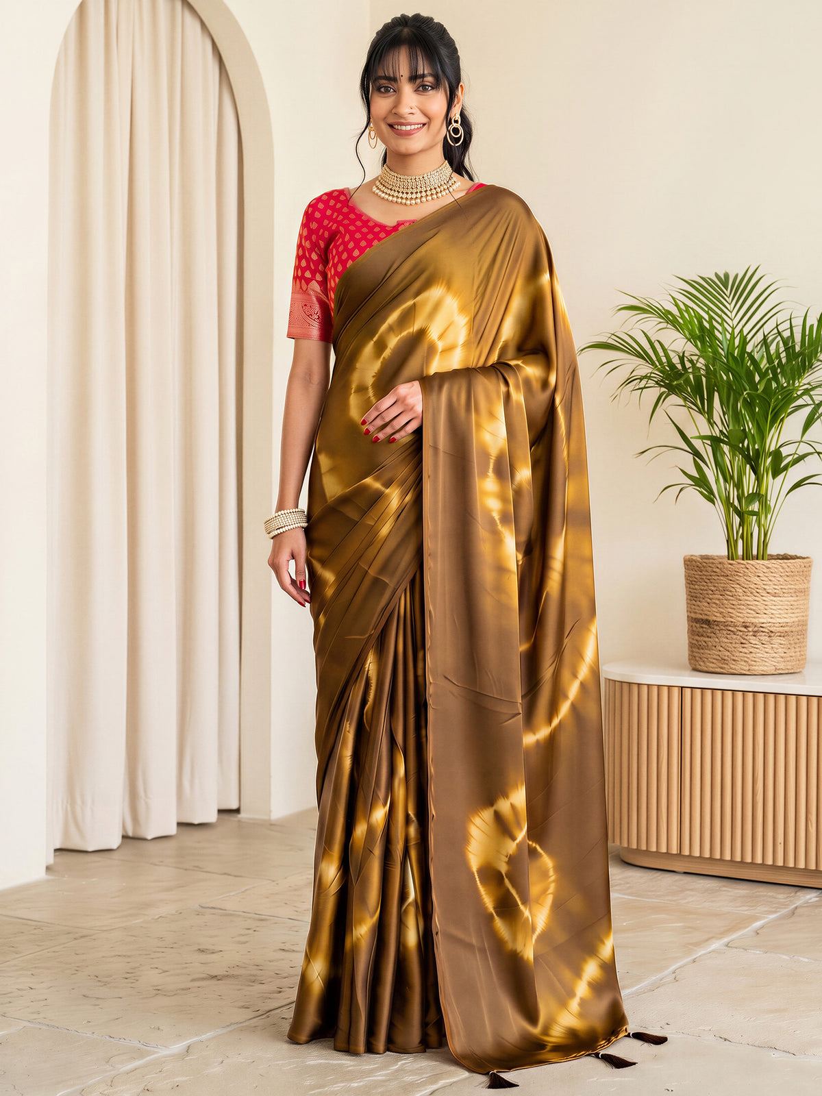 Woman wearing brown satin silk saree with tie-and-dye resist pattern and red blouse