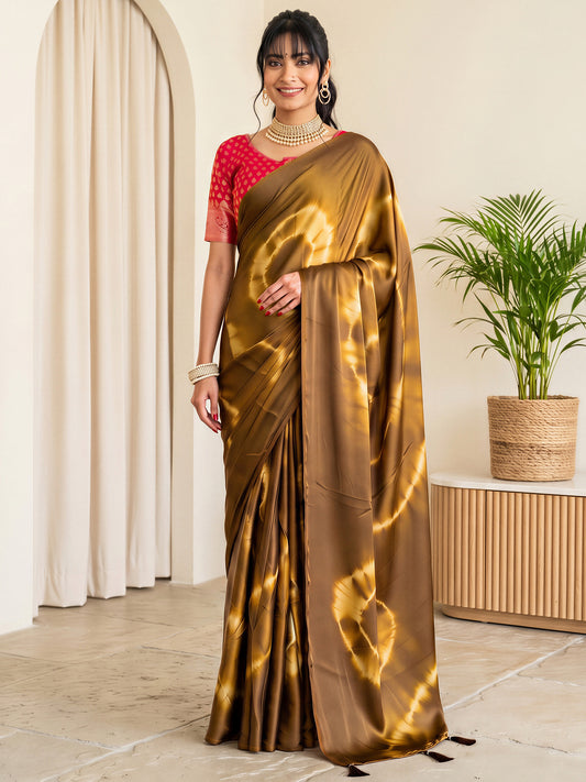 Woman wearing brown satin silk saree with tie-and-dye resist pattern and red blouse