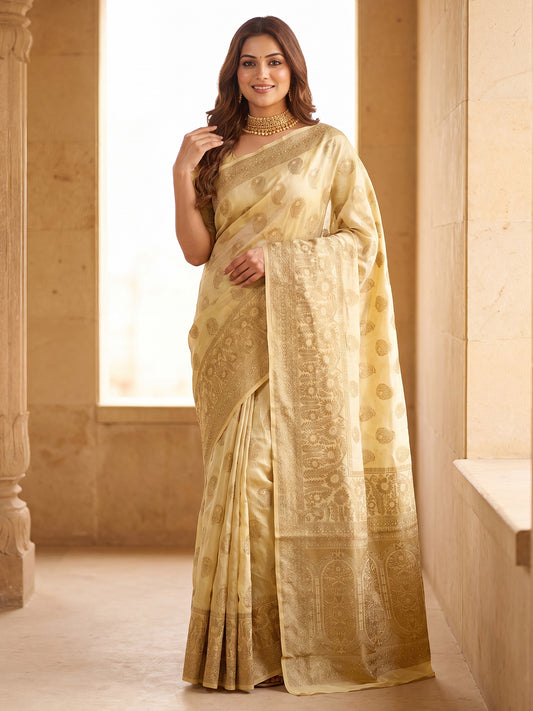 Woman wearing cream silk blend saree with zari butta (metallic motif) work and cream blouse