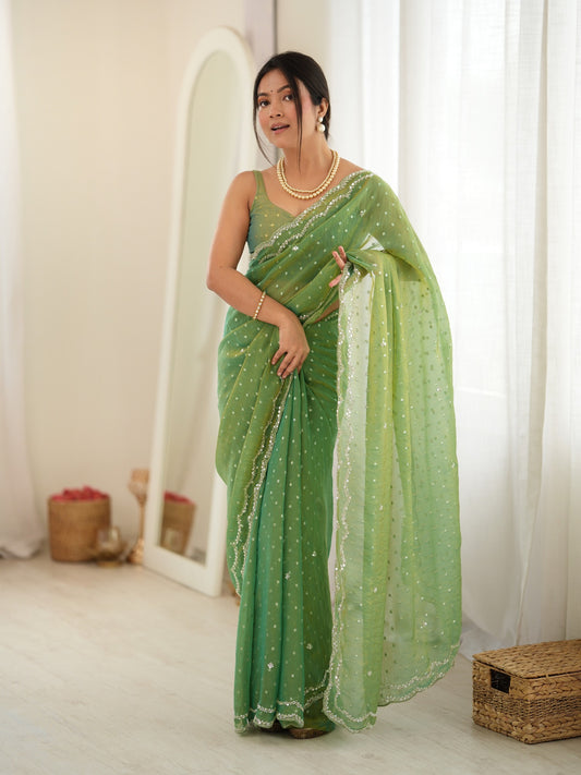 Woman wearing lime green georgette saree with zari butta (metallic motif) work and lime green blouse