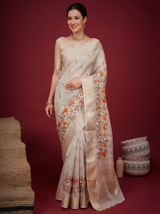 Woman wearing beige silk blend saree with embroidered motif work and beige blouse