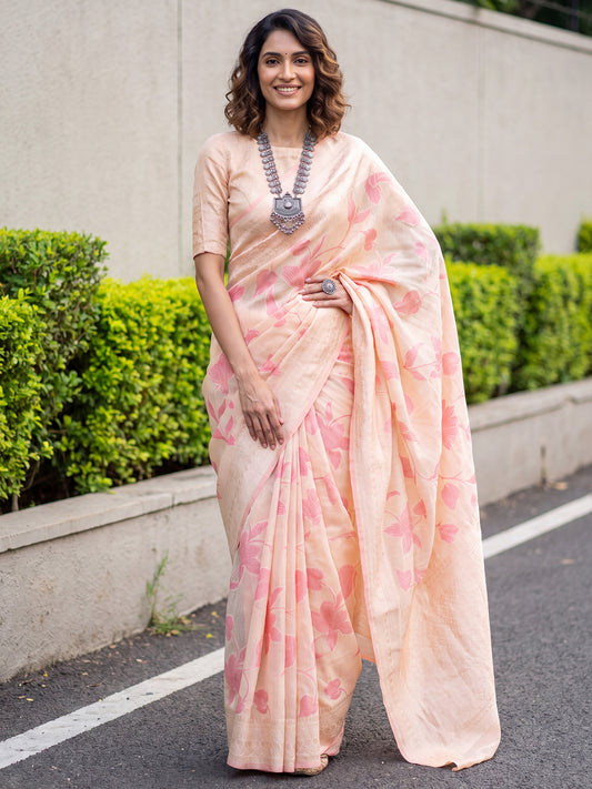 Woman wearing cream linen saree with traditional indian motif work and cream blouse