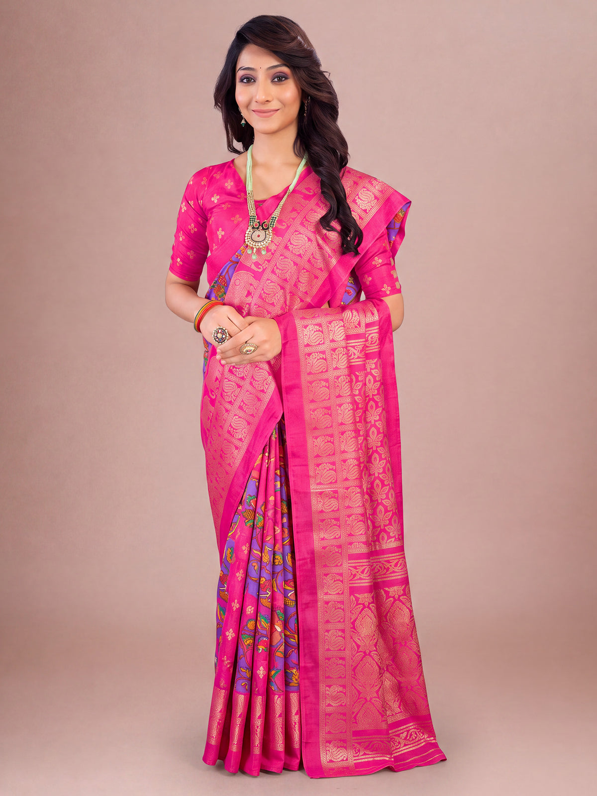 Woman wearing pink cotton blend saree with traditional indian motif work and pink blouse