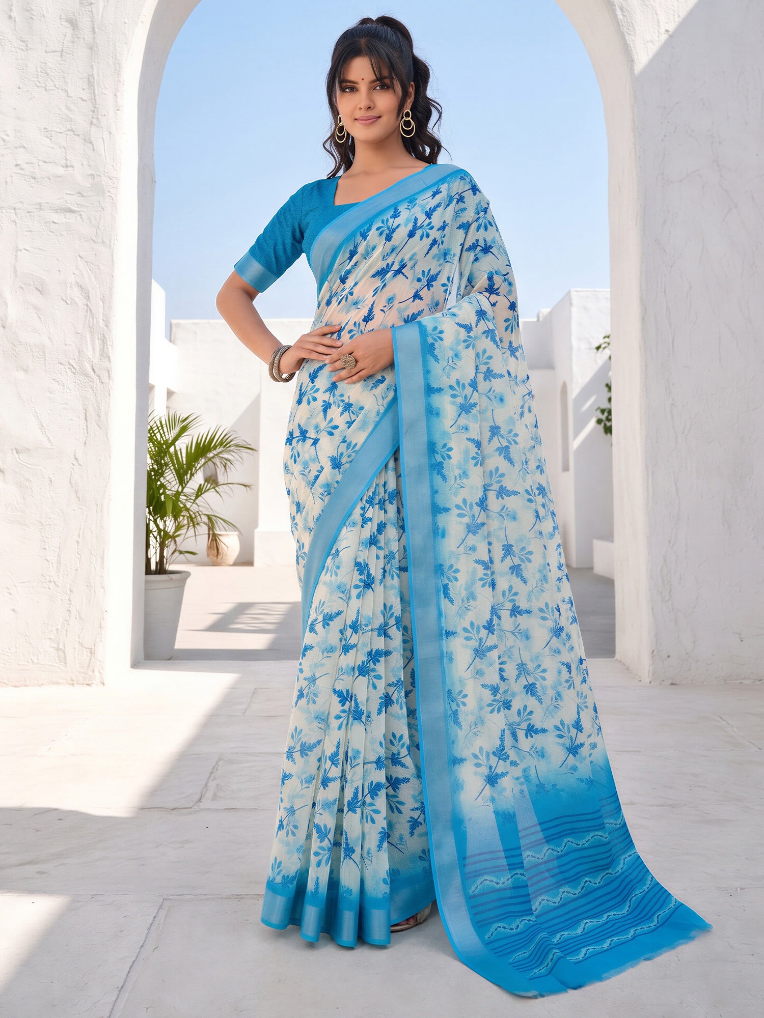 Woman wearing off white cotton linen saree with botanical floral and leaf design and blue blouse