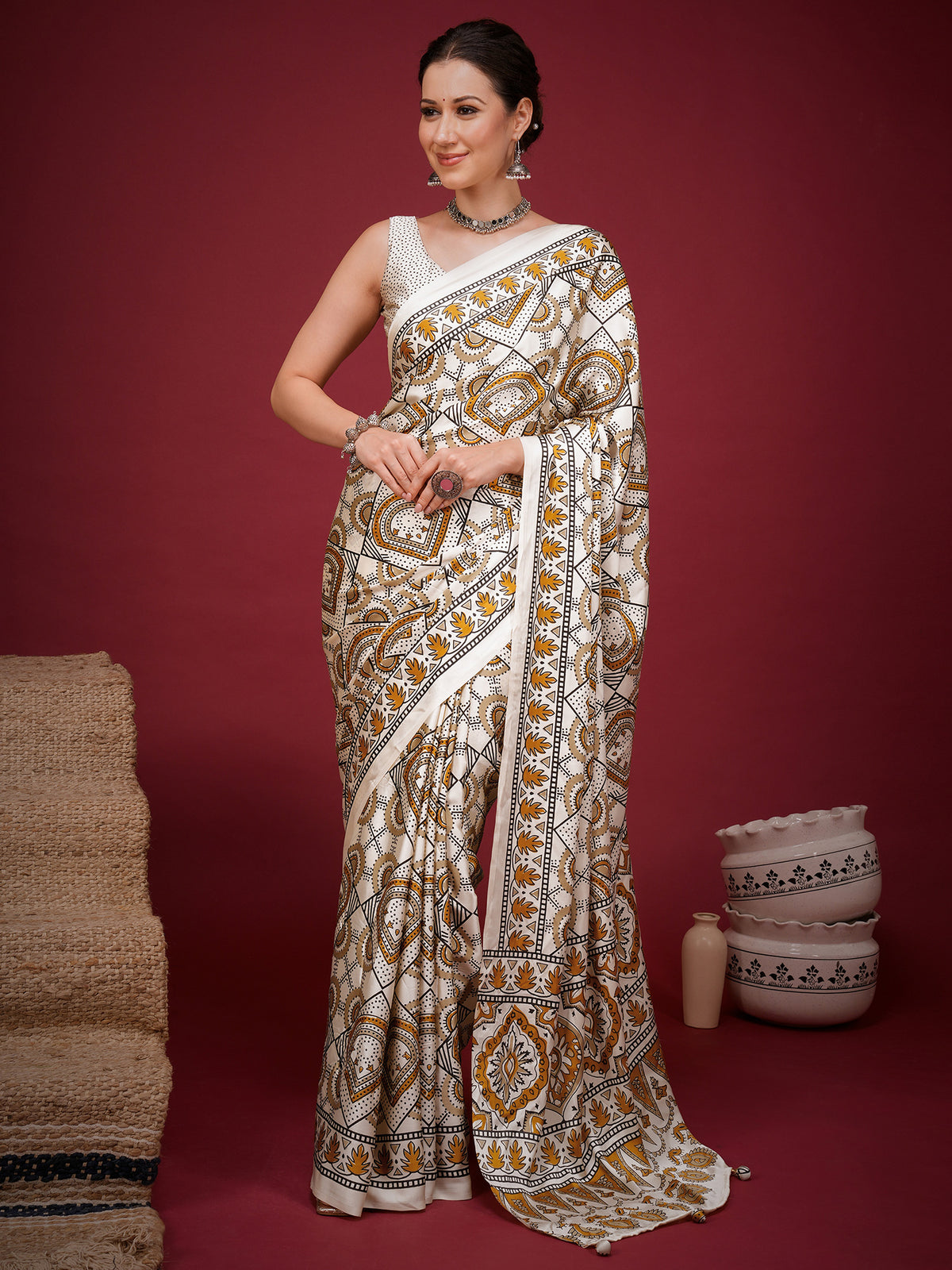 Woman wearing off white satin saree with ajrak block-print motif work and off white blouse