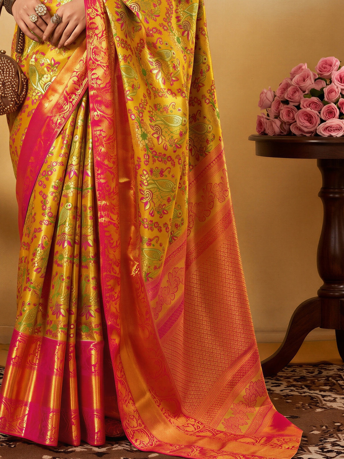 Pallu detail of yellow silk blend saree showing traditional indian motif work and zari border