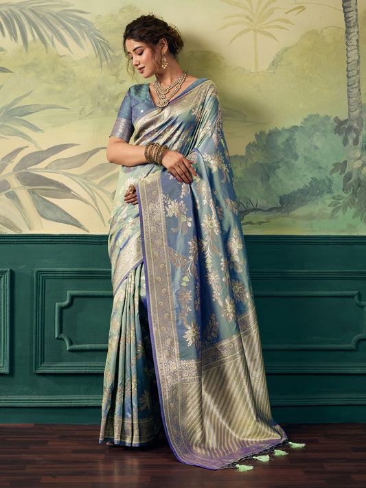 Woman wearing light blue banarasi silk saree with woven motif design and light blue blouse