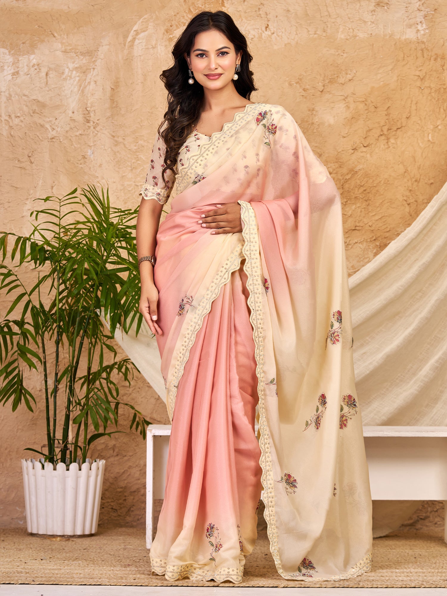 Woman wearing peach georgette saree with all-over floral design and peach blouse