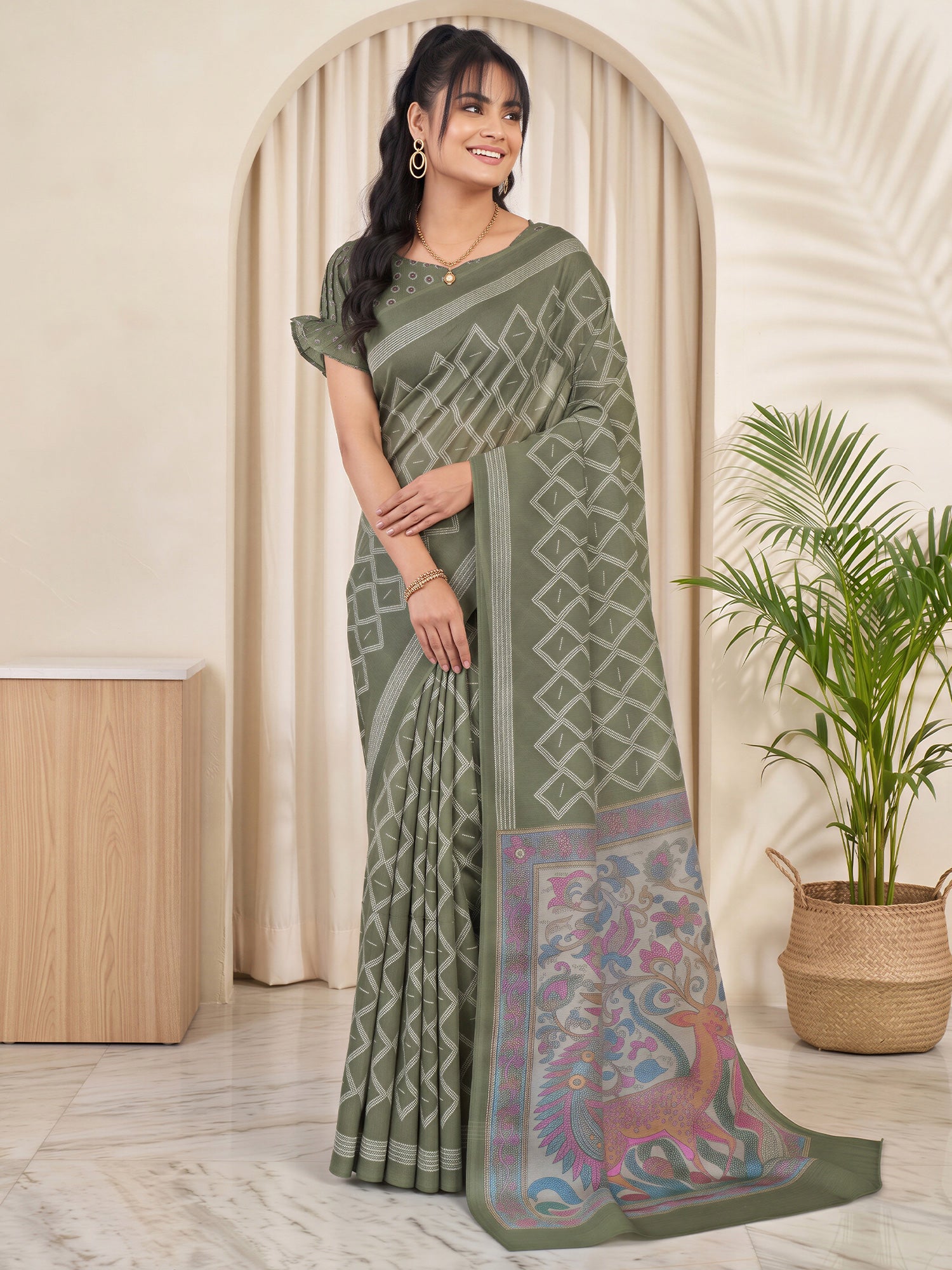 Woman wearing olive linen blend saree with traditional indian motif work and olive blouse