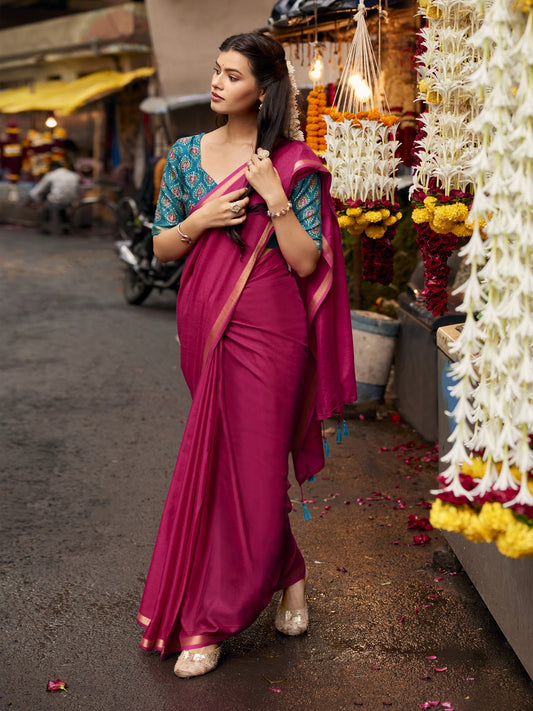 Woman wearing pink cotton blend saree with clean solid-tone finish and turquoise blue blouse