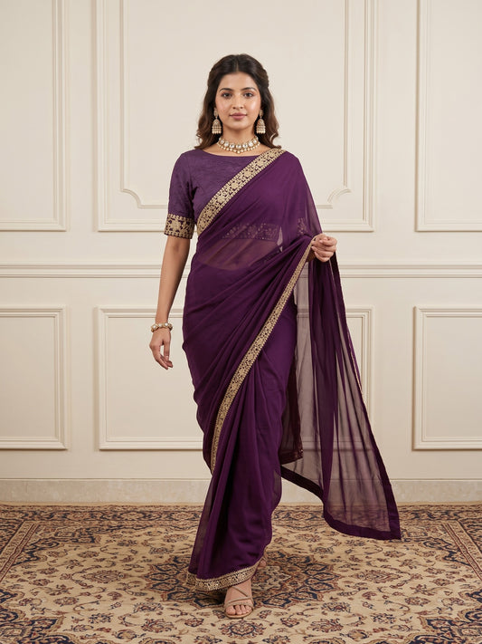 Woman wearing magenta satin silk saree with clean solid-tone finish and magenta blouse