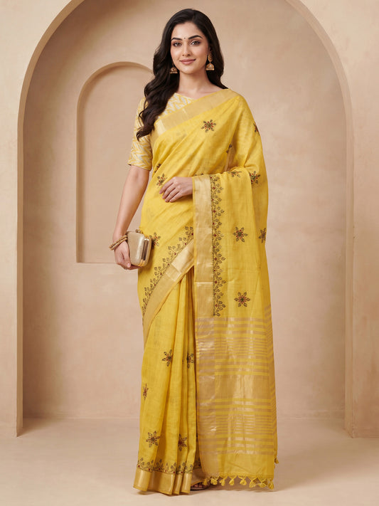 Woman wearing yellow cotton linen saree with embroidered motif work and yellow blouse