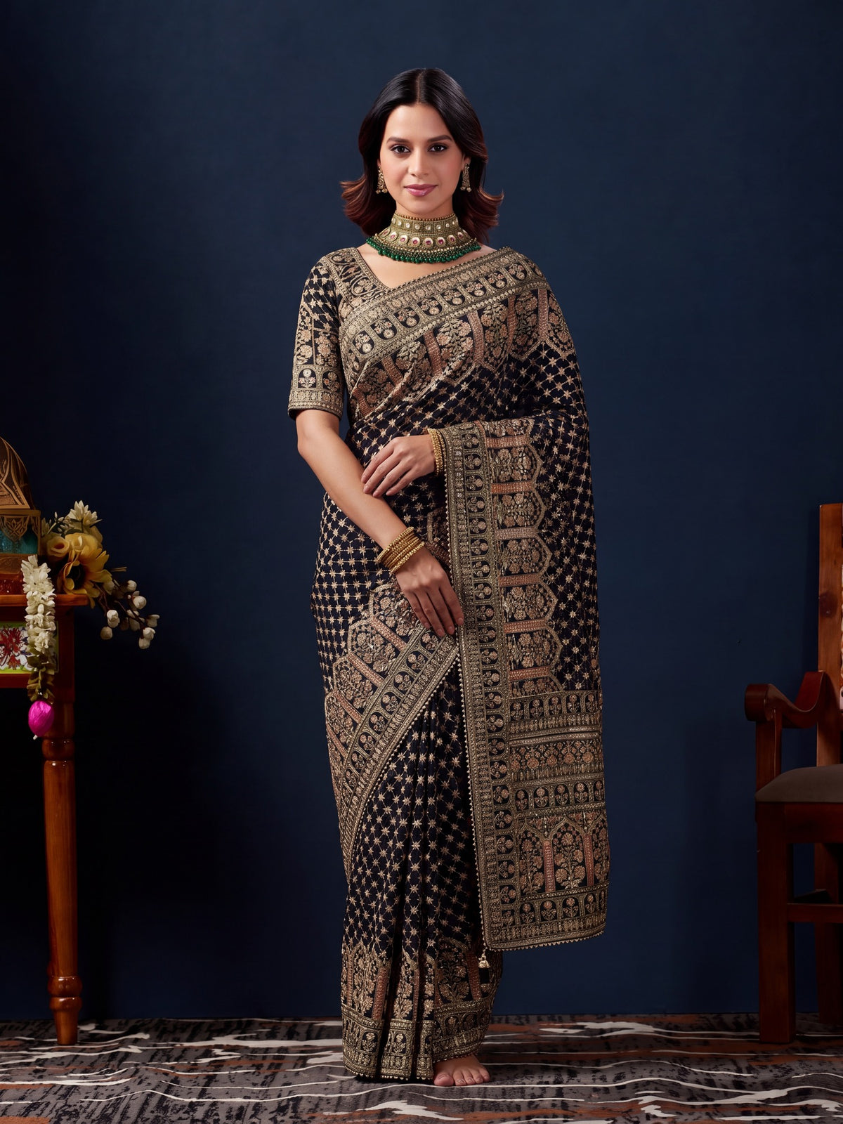 Woman wearing black silk blend saree with traditional indian motif work and black blouse
