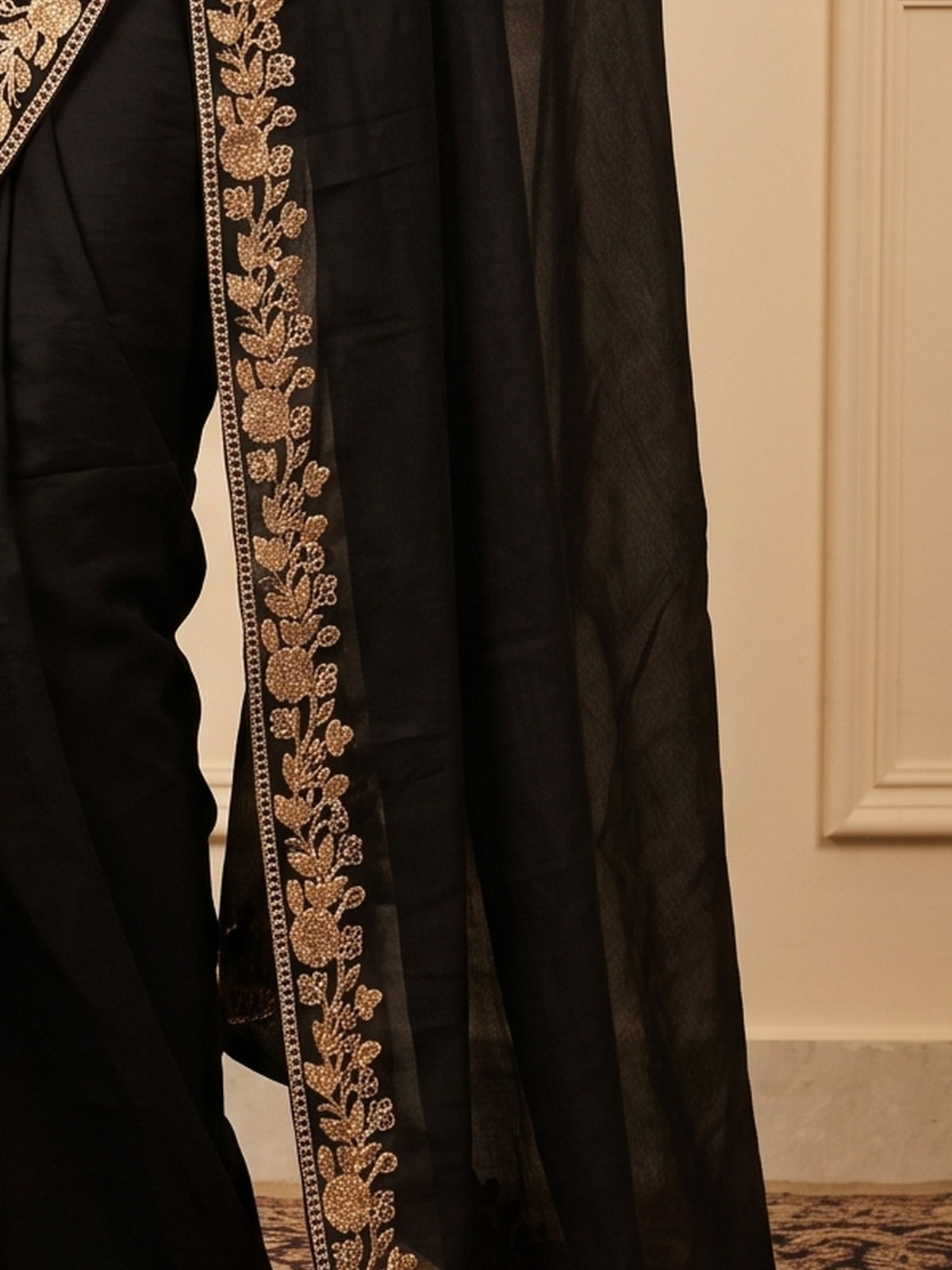 Pallu detail of black vichitra silk saree showing ornamented surface design and embellished border