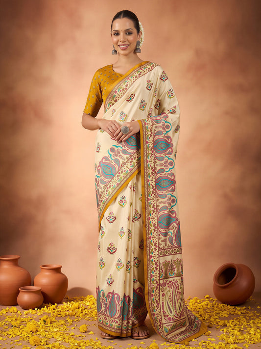 Woman wearing off white silk blend saree with metallic foil print work and yellow blouse
