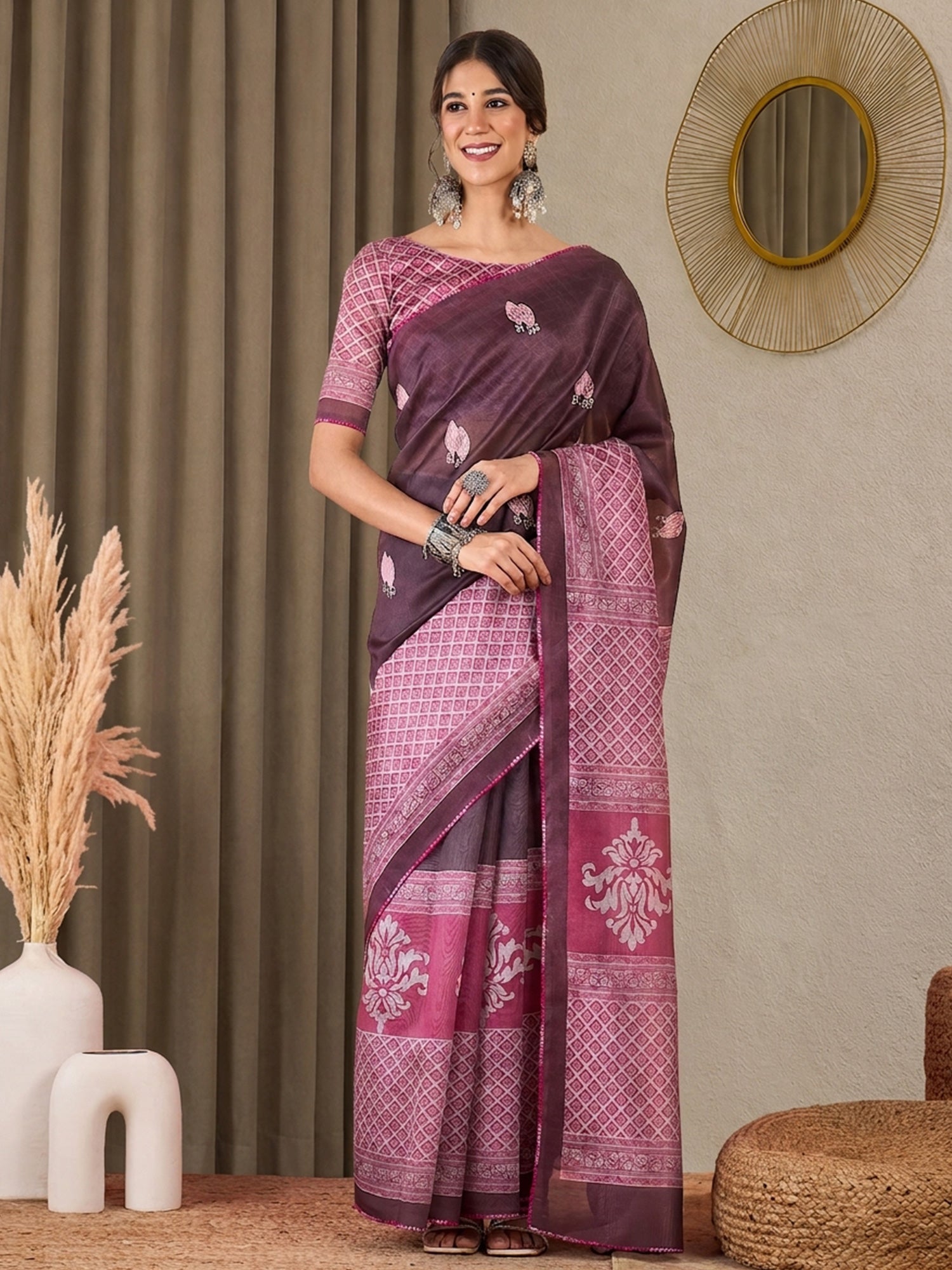 Woman wearing mauve silk blend saree with all-over floral design and pink blouse