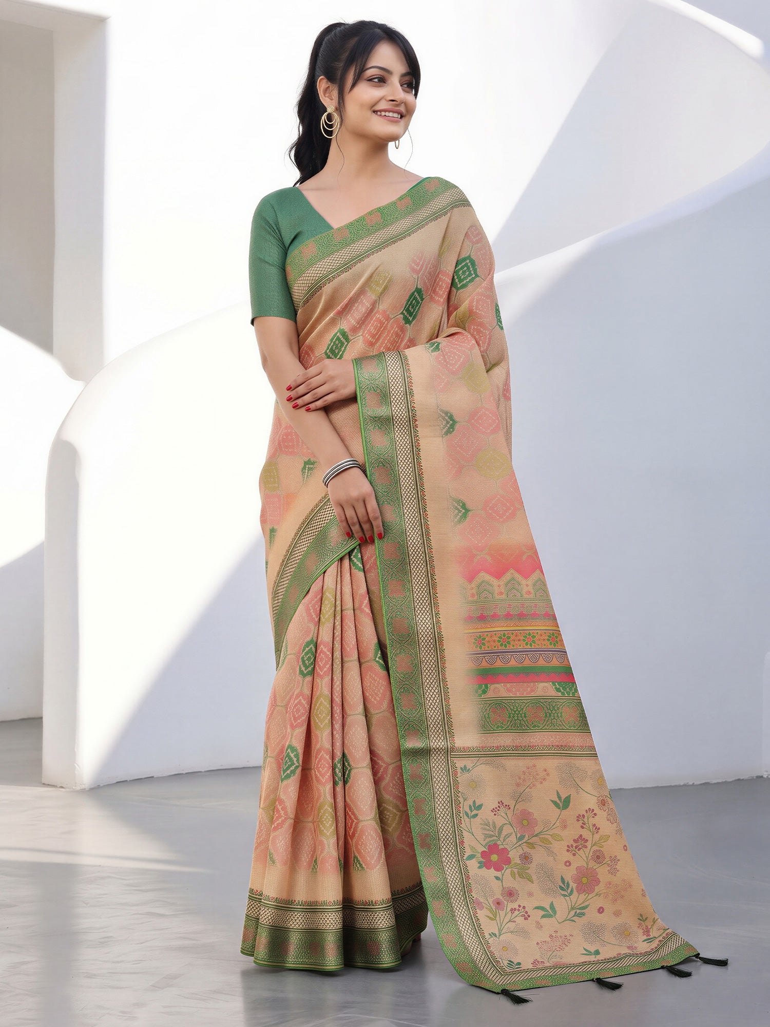 Woman wearing light brown cotton silk saree with traditional indian motif work and green blouse