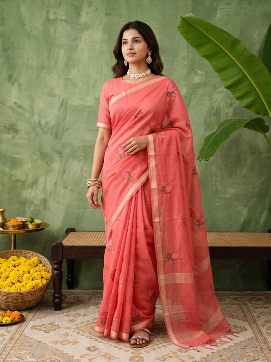 Woman wearing peach kota doria cotton saree with embroidered motif work and peach blouse