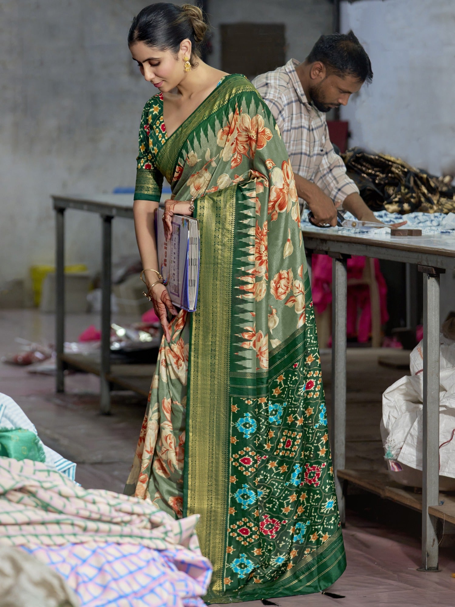 Woman wearing sea green tussar silk saree with ikat resist-dyed pattern and green blouse
