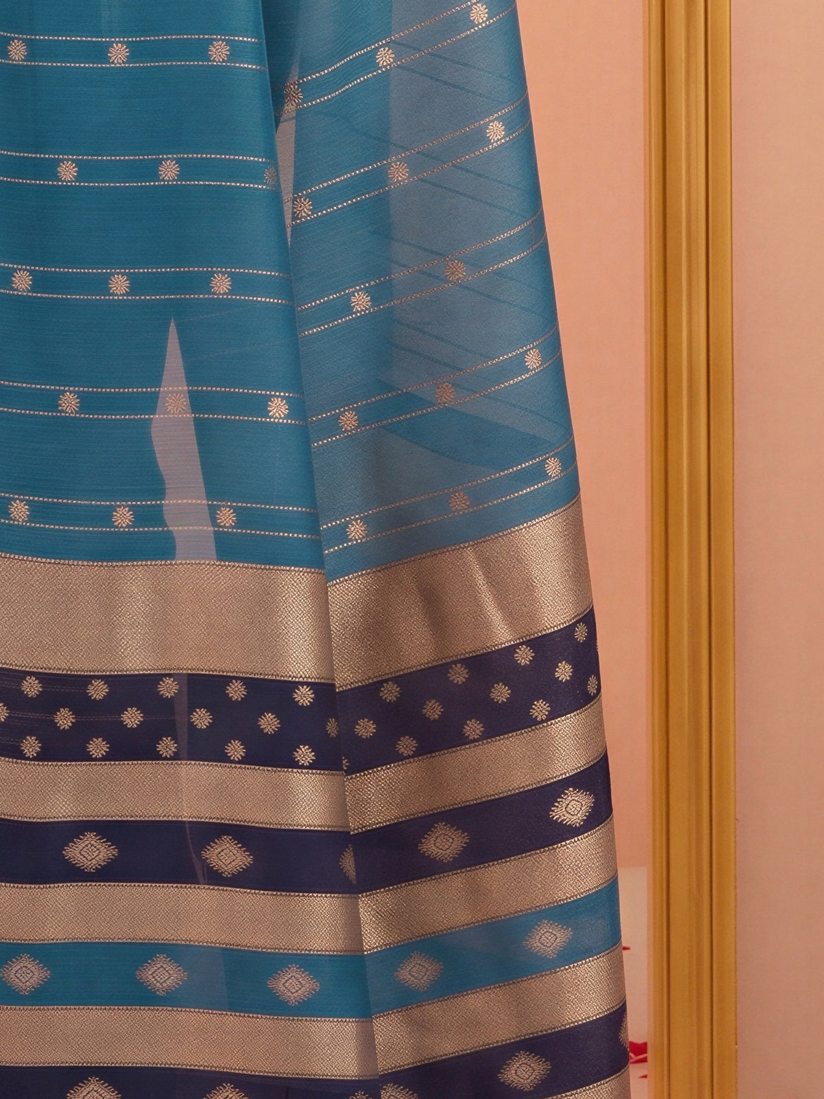 Pallu detail of light blue silk blend saree showing woven motif design and zari border