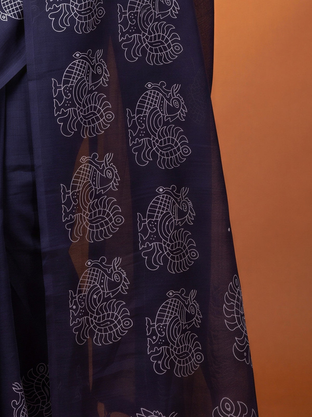 Pallu detail of purple linen blend saree showing traditional indian motif work and printed border