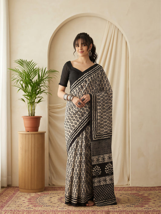 Woman wearing beige bhagalpuri silk saree with batik wax-resist design and black blouse