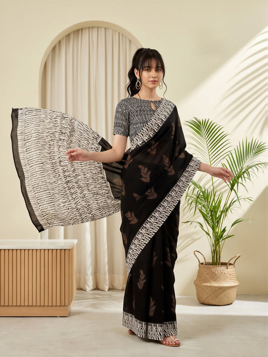 Woman wearing black bhagalpuri silk saree with batik wax-resist design and black blouse
