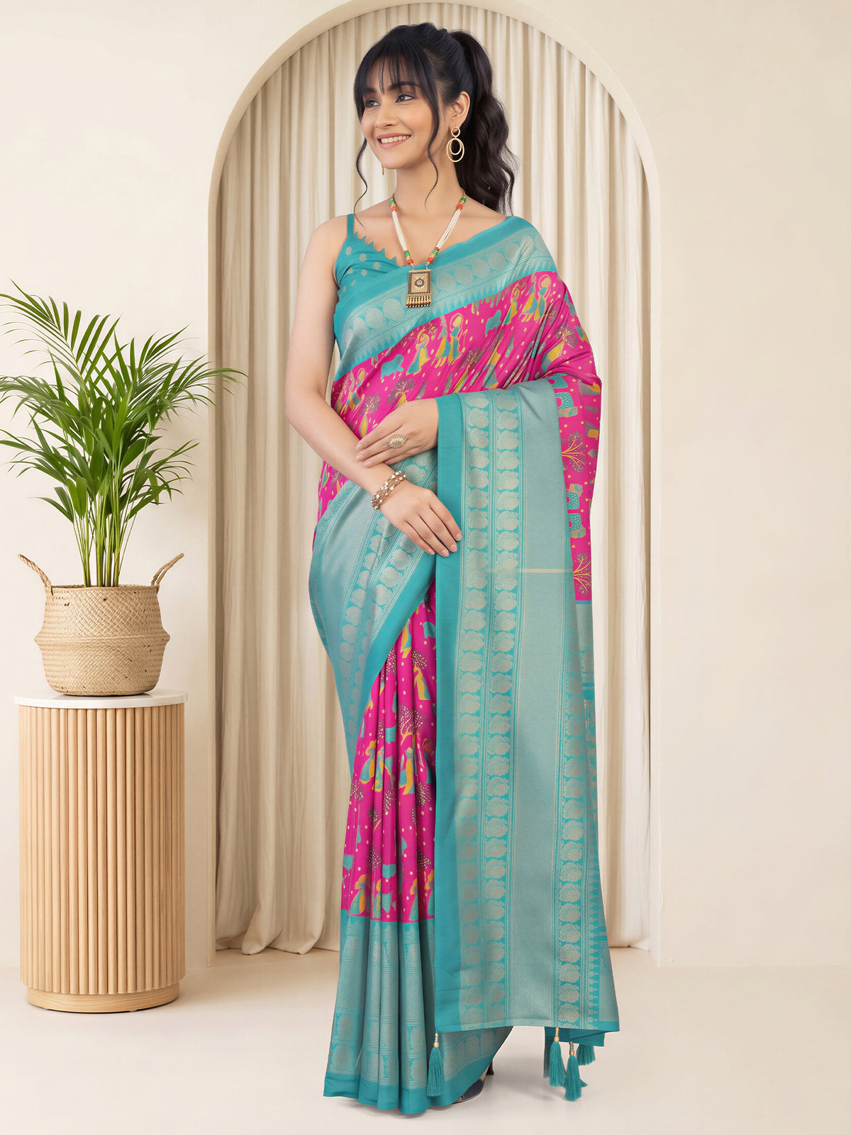 Woman wearing pink cotton blend saree with traditional indian motif work and turquoise blouse