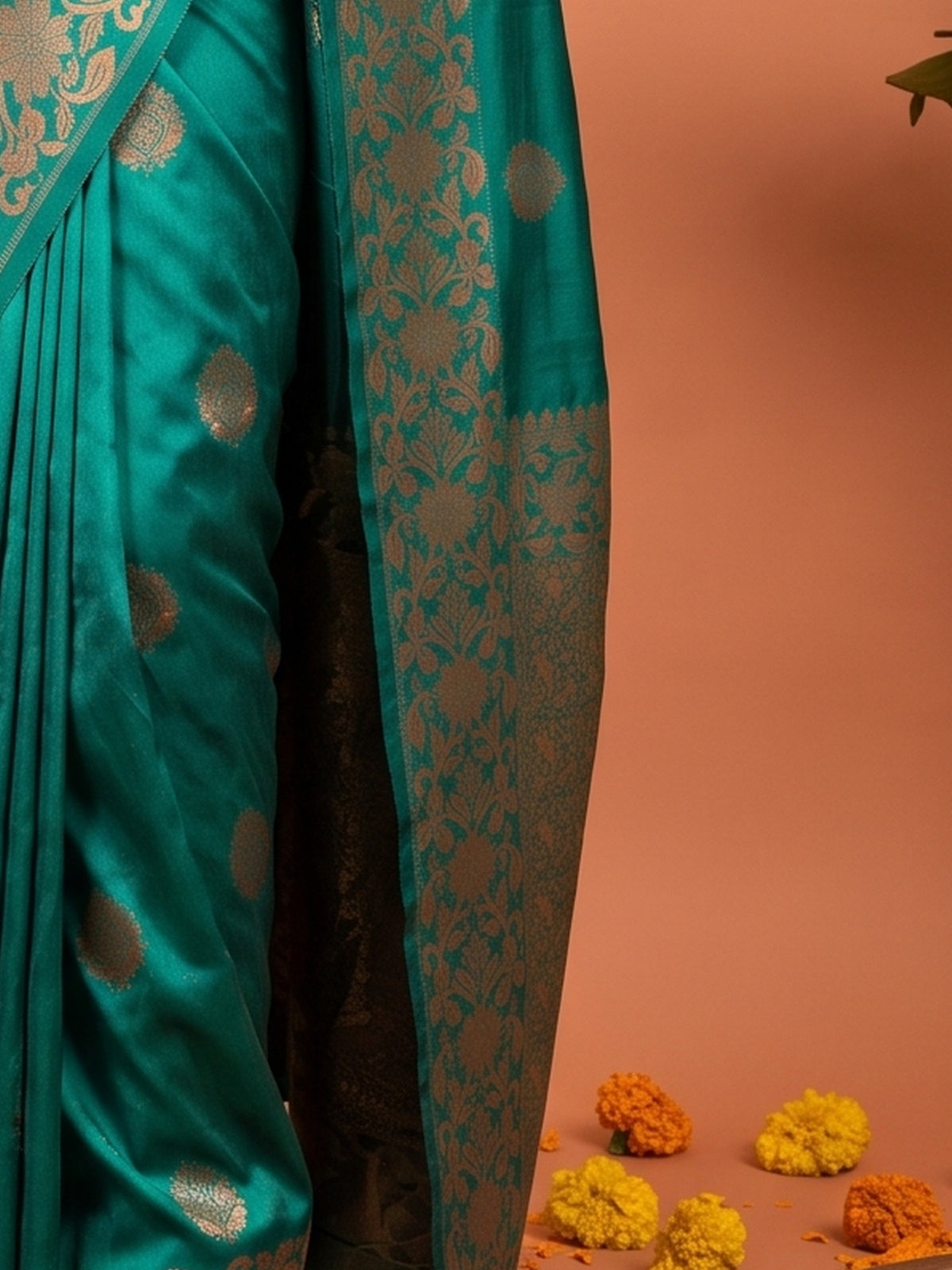 Pallu detail of teal blue silk blend saree showing zari butta (metallic motif) work and zari border