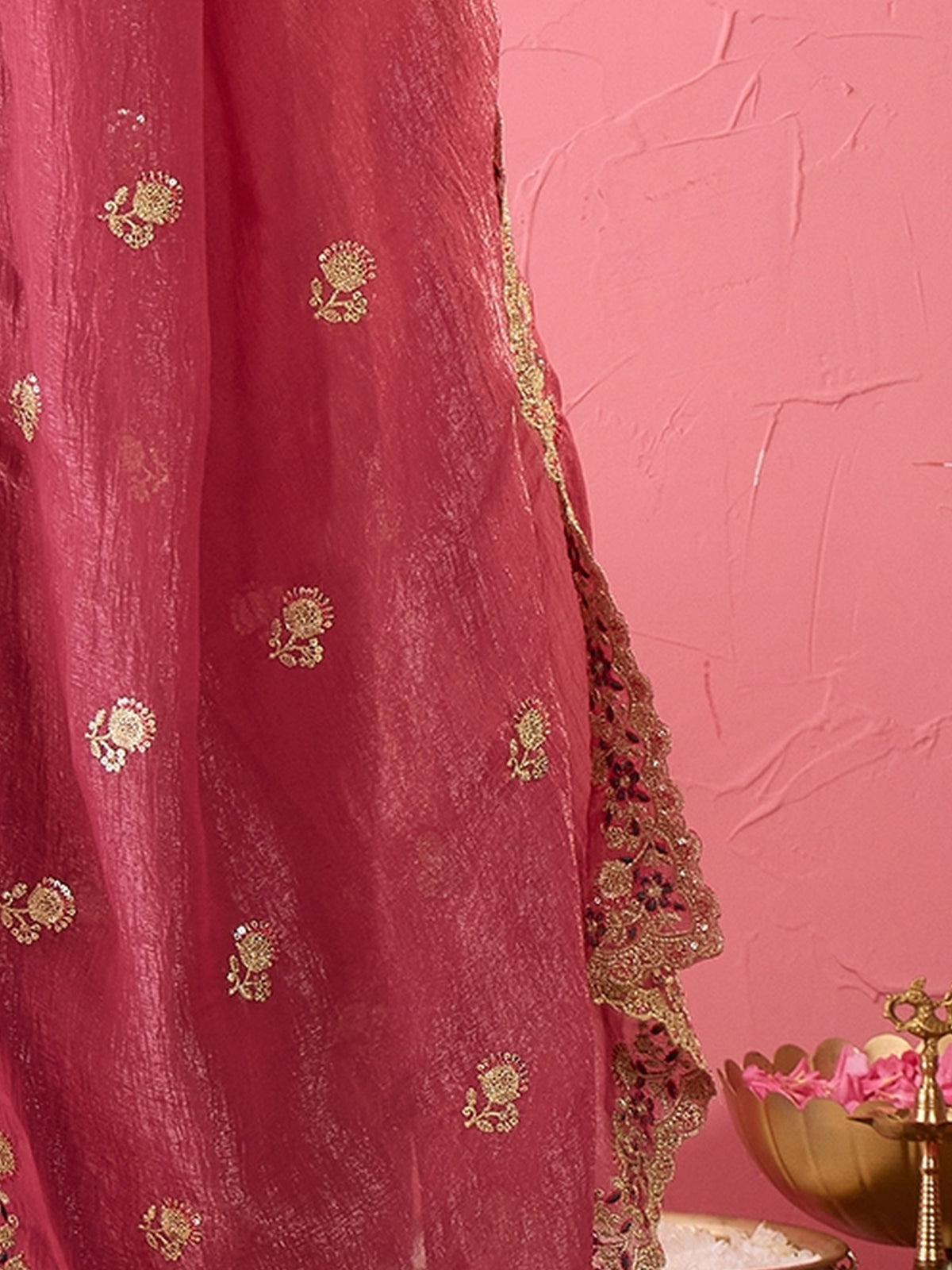 Pallu detail of mauve tissue saree showing ornamented surface design and zari border