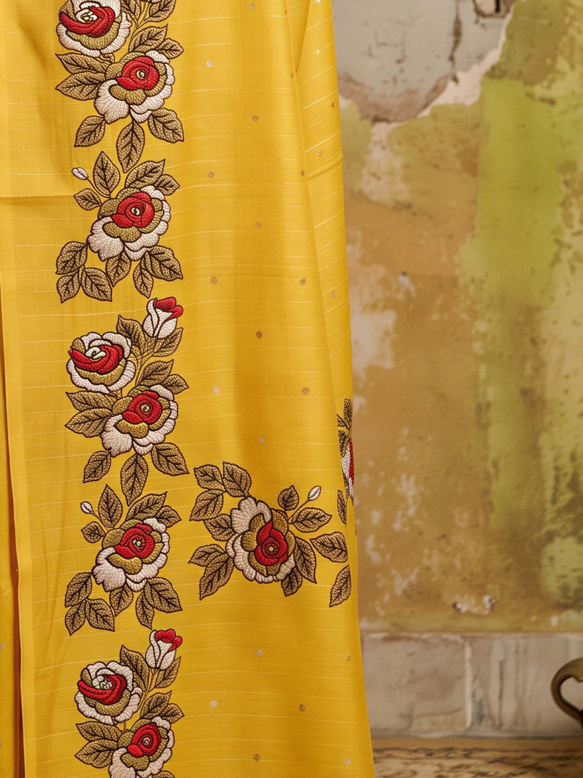Pallu detail of yellow dola silk saree showing zari butta (metallic motif) work and zari border