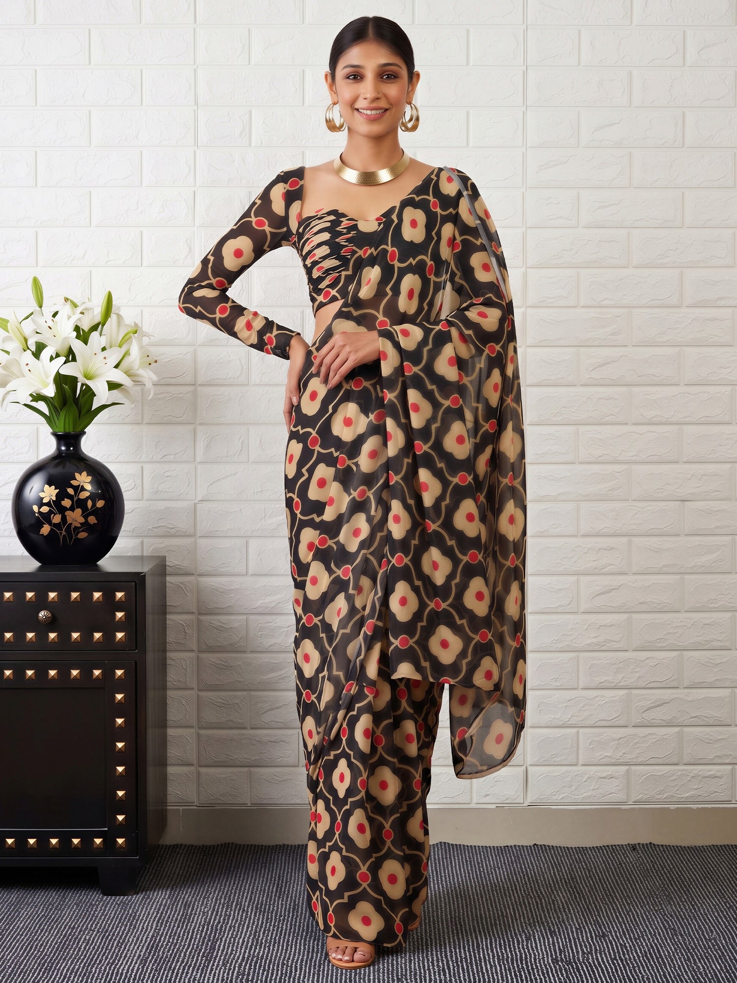 Woman wearing black satin saree with all-over floral design and black blouse
