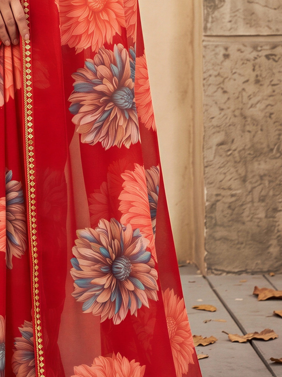 Pallu detail of red georgette saree showing all-over floral design and embellished border