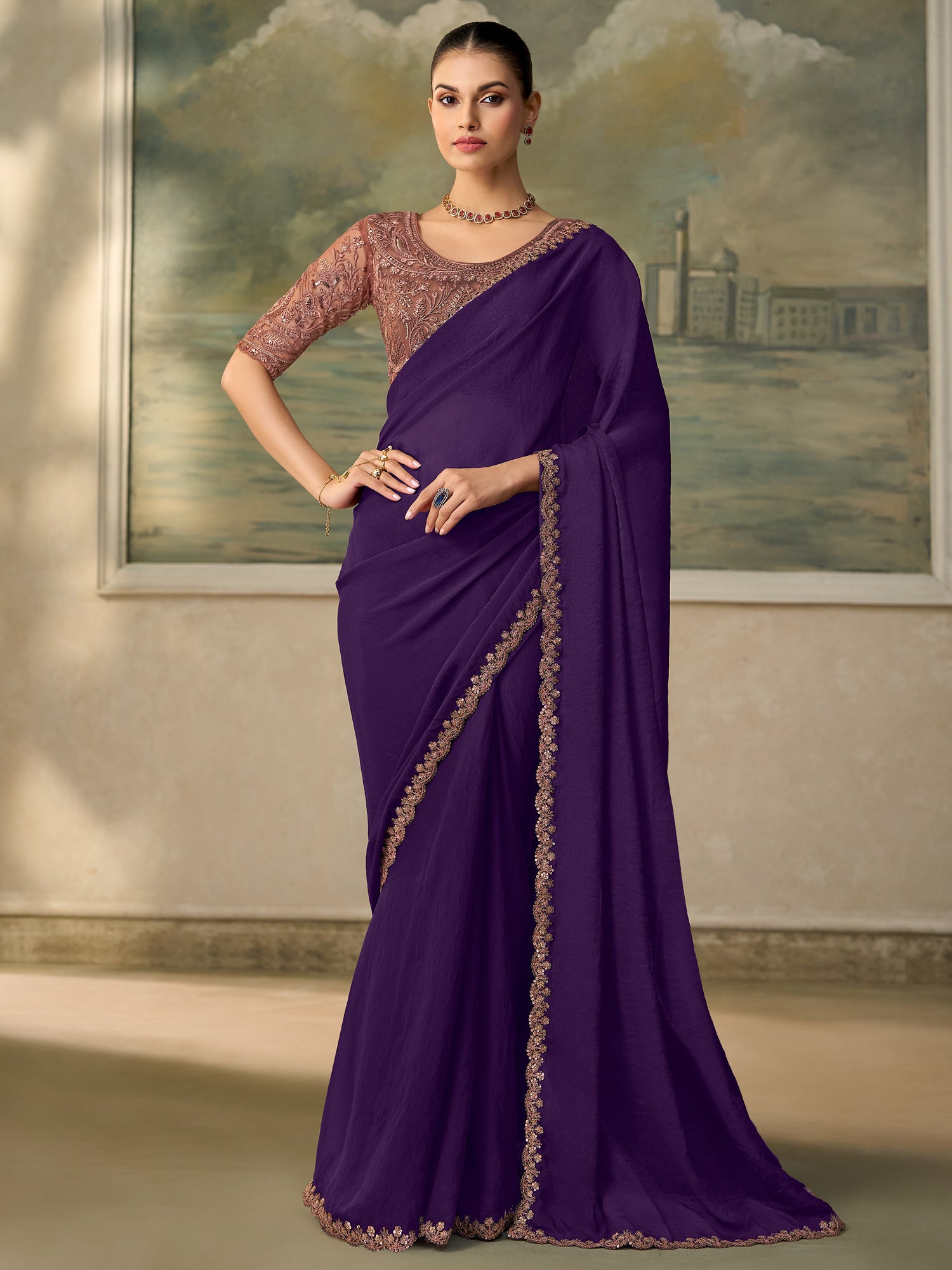 Woman wearing purple georgette saree with embroidered motif work and rose gold blouse