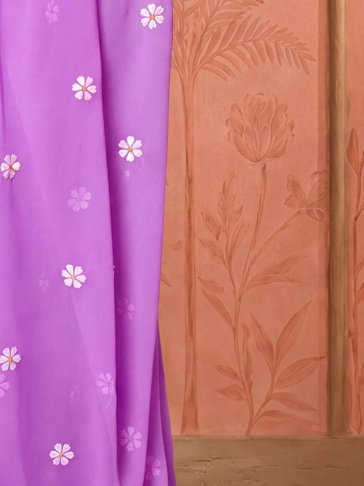 Pallu detail of lavender georgette saree showing embroidered motif work and solid border
