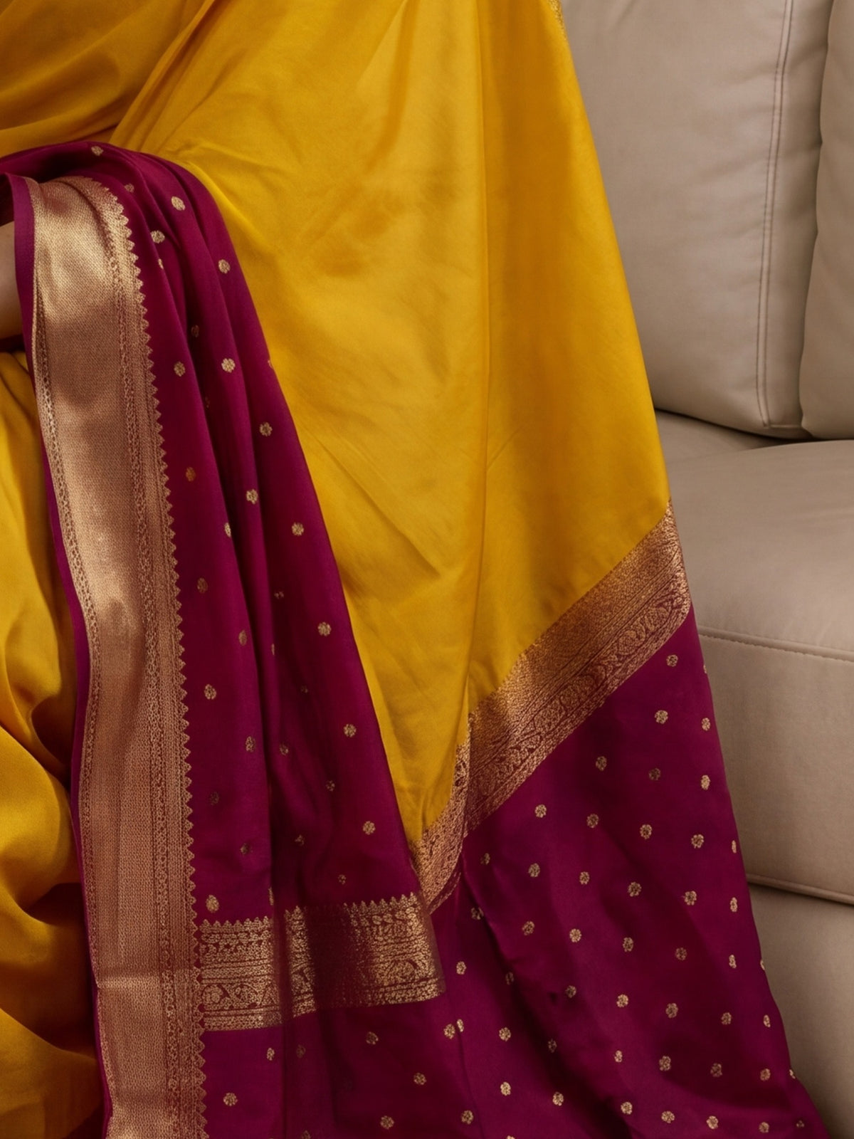 Pallu detail of mustard mysore silk saree showing zari butta (metallic motif) work and zari border