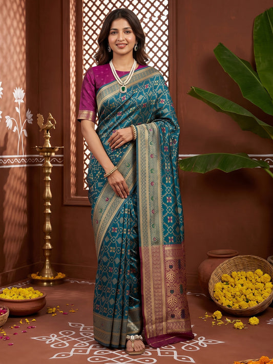 Woman wearing teal blue silk blend saree with traditional indian motif work and purple blouse