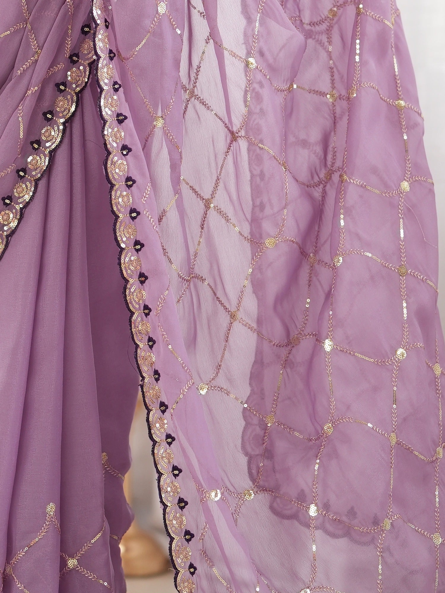 Pallu detail of lavender georgette saree showing ornamented surface design and embellished border