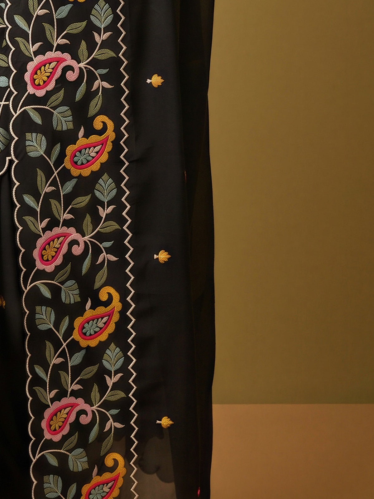 Pallu detail of black georgette saree showing embroidered motif work and embroidered border