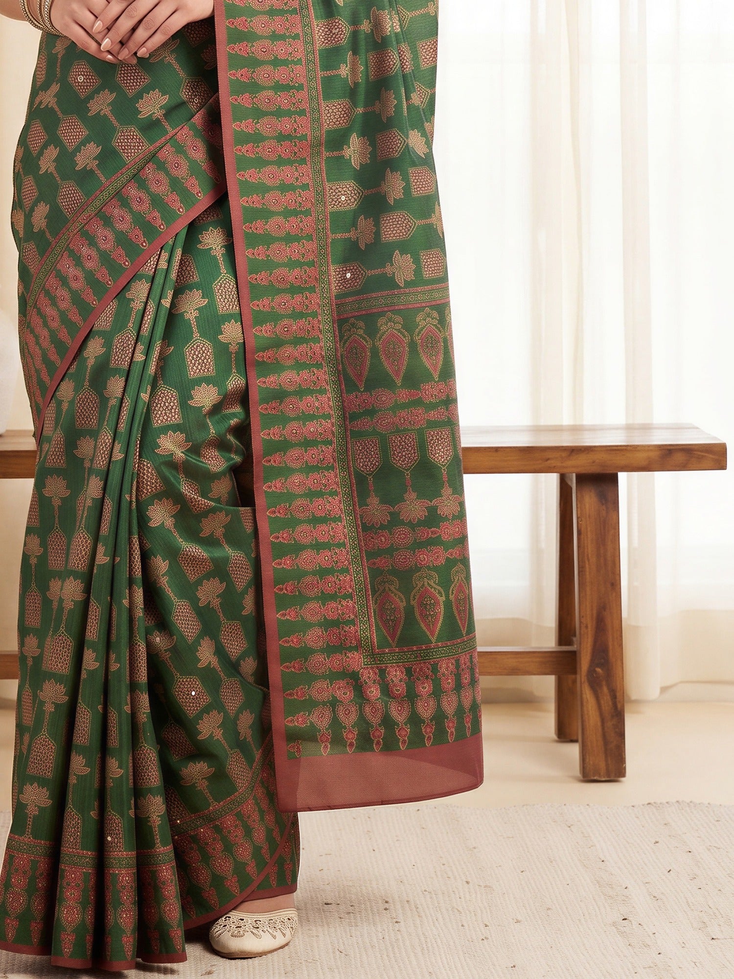 Pallu detail of green silk blend saree showing ajrak block-print motif work and embellished border
