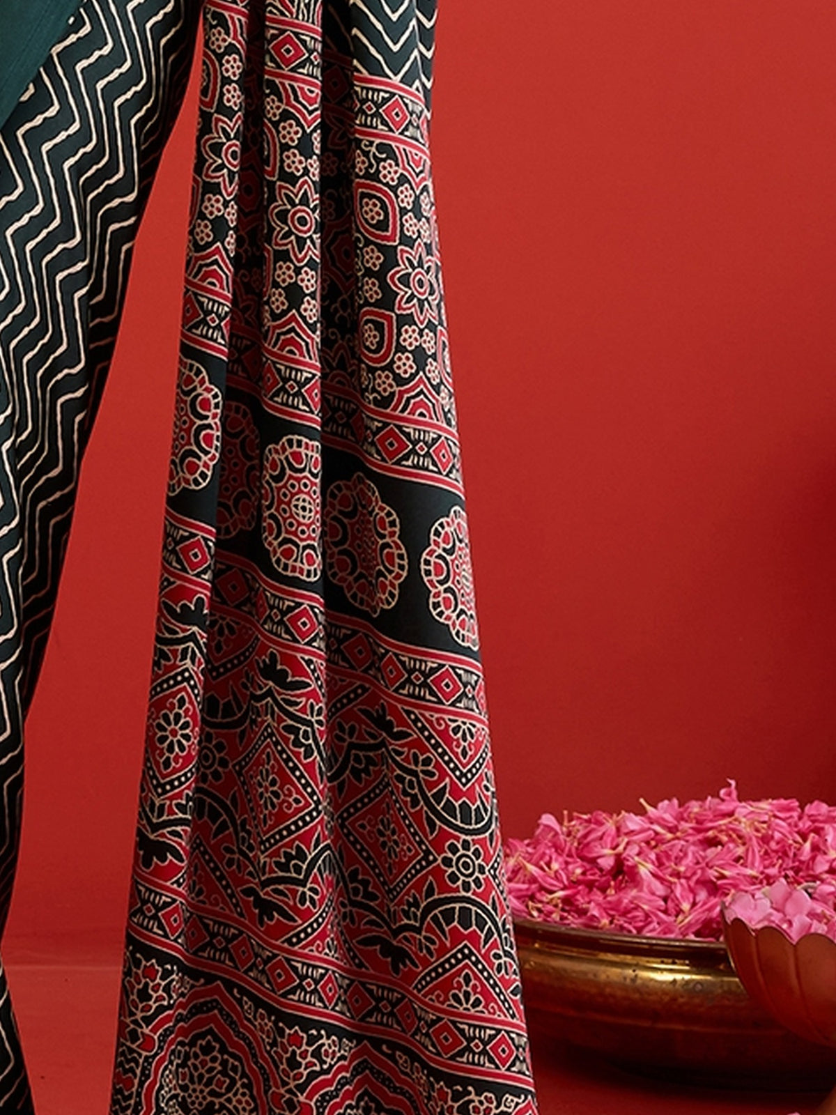 Pallu detail of green satin saree showing chevron zigzag pattern and printed border