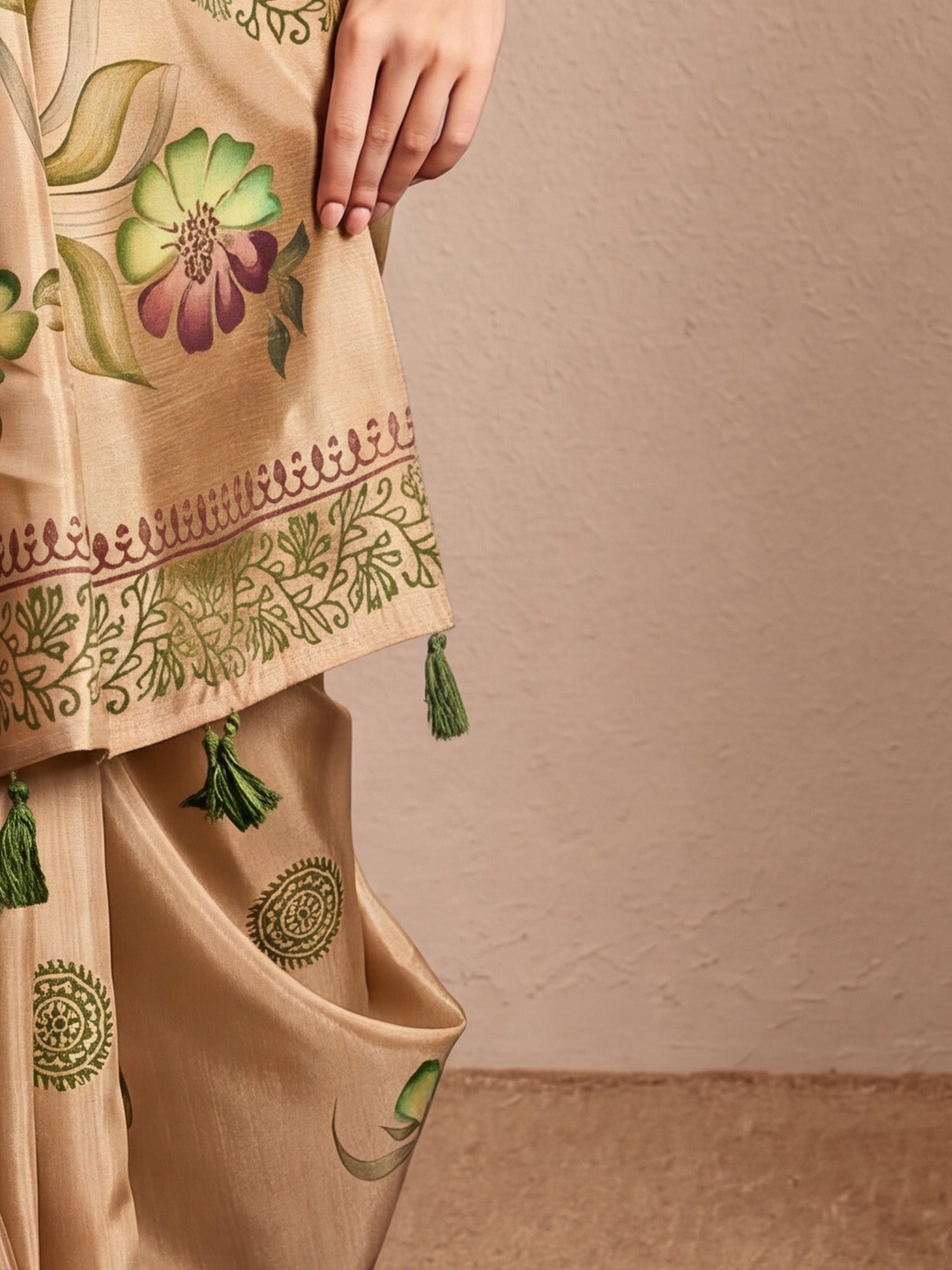 Pallu detail of beige silk blend saree showing hand-painted motif work and printed border