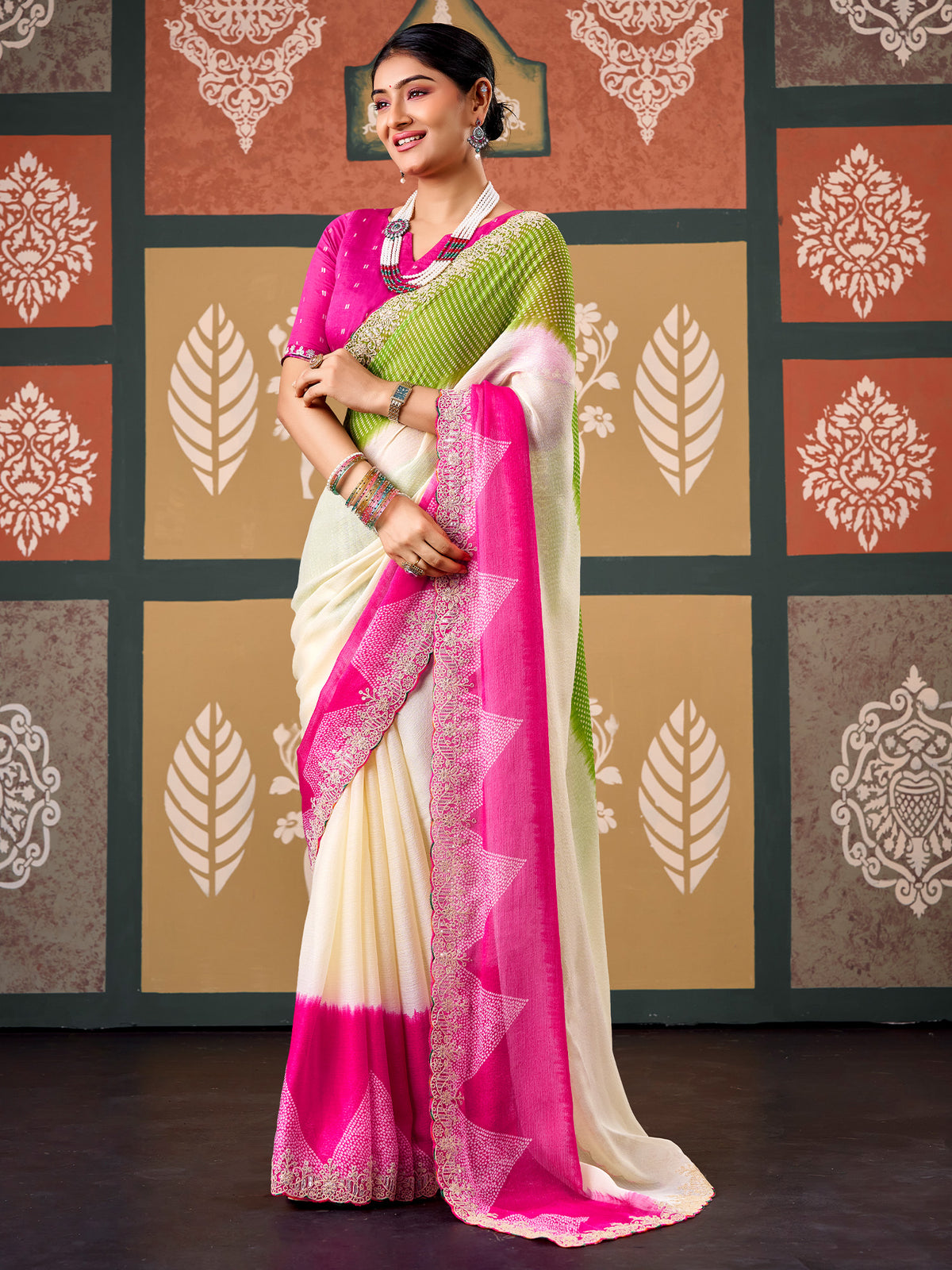 Woman wearing cream chiffon saree with bandhani tie-dye dot work and pink blouse