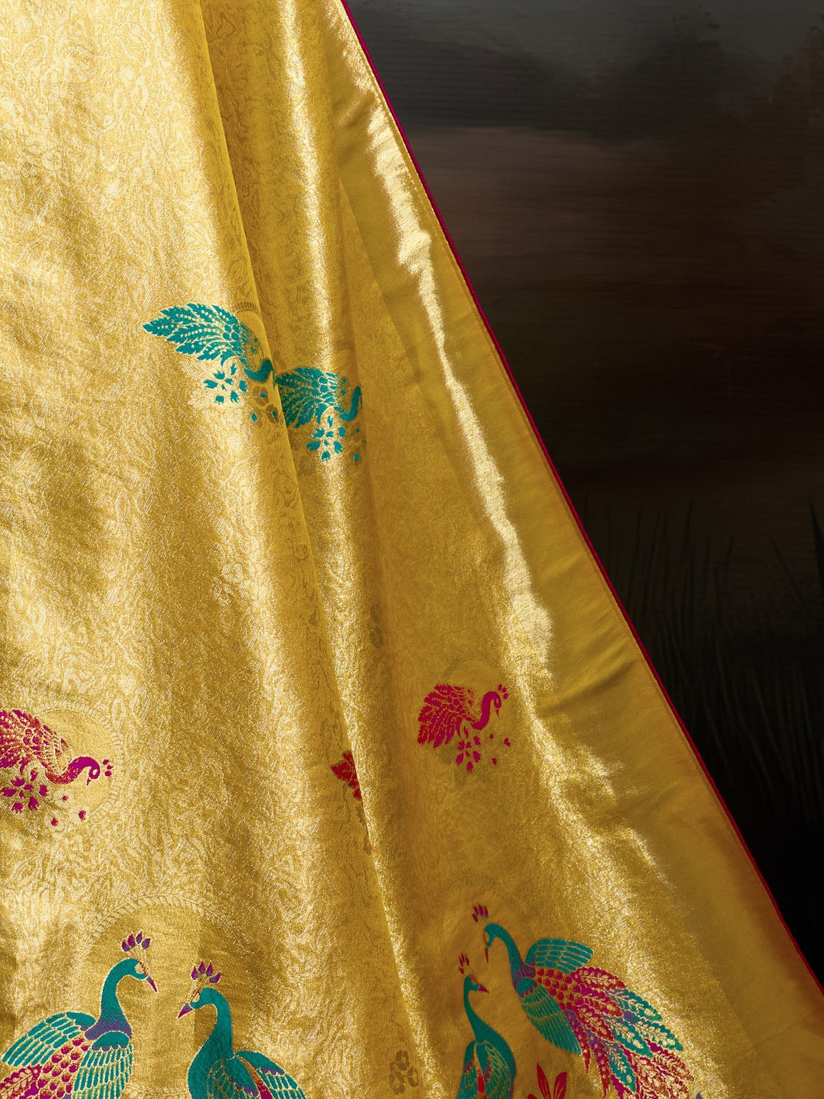Pallu detail of yellow banarasi silk saree showing woven motif design and zari border