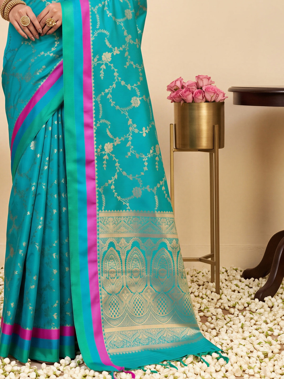 Pallu detail of teal blue pure silk saree showing traditional indian motif work and zari border