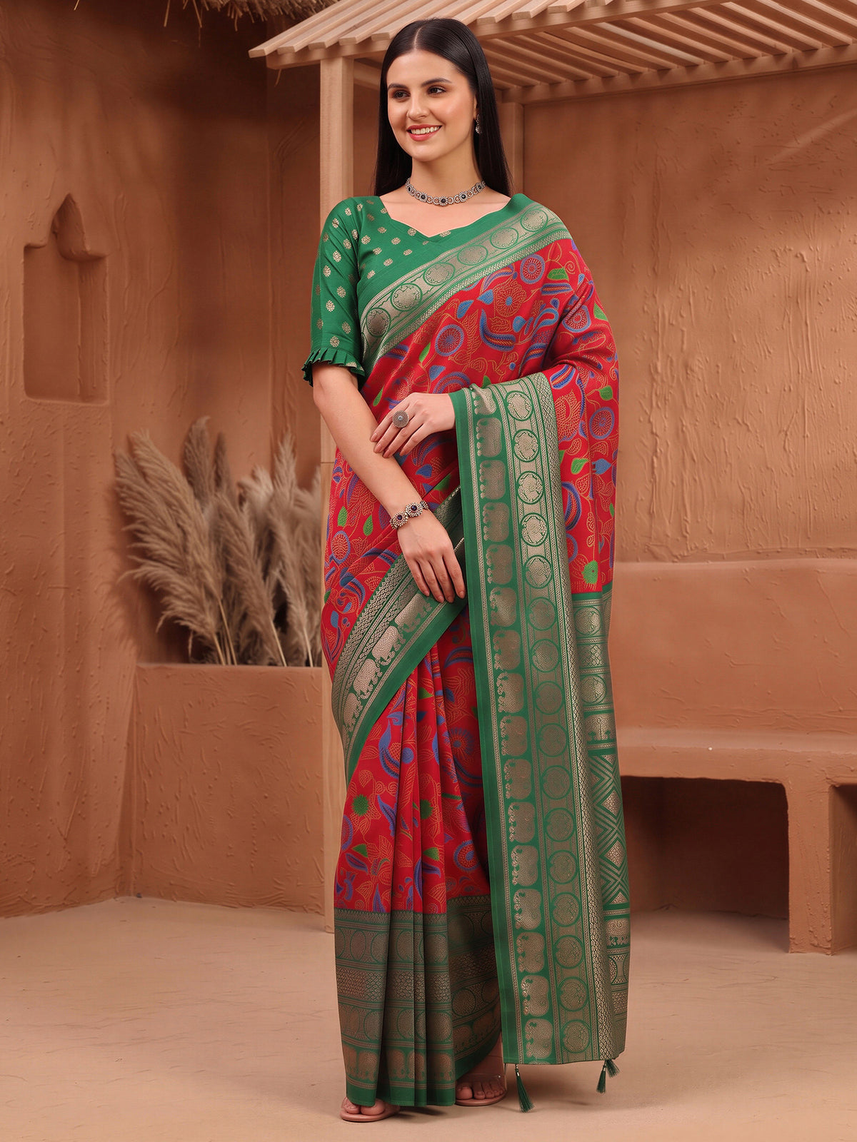 Woman wearing red cotton blend saree with botanical floral and leaf design and green blouse