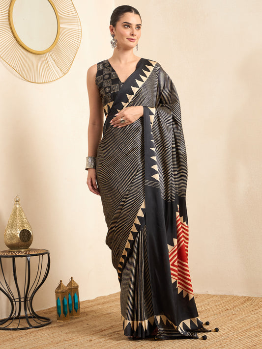 Woman wearing black pure crepe saree with striped pattern design and black blouse